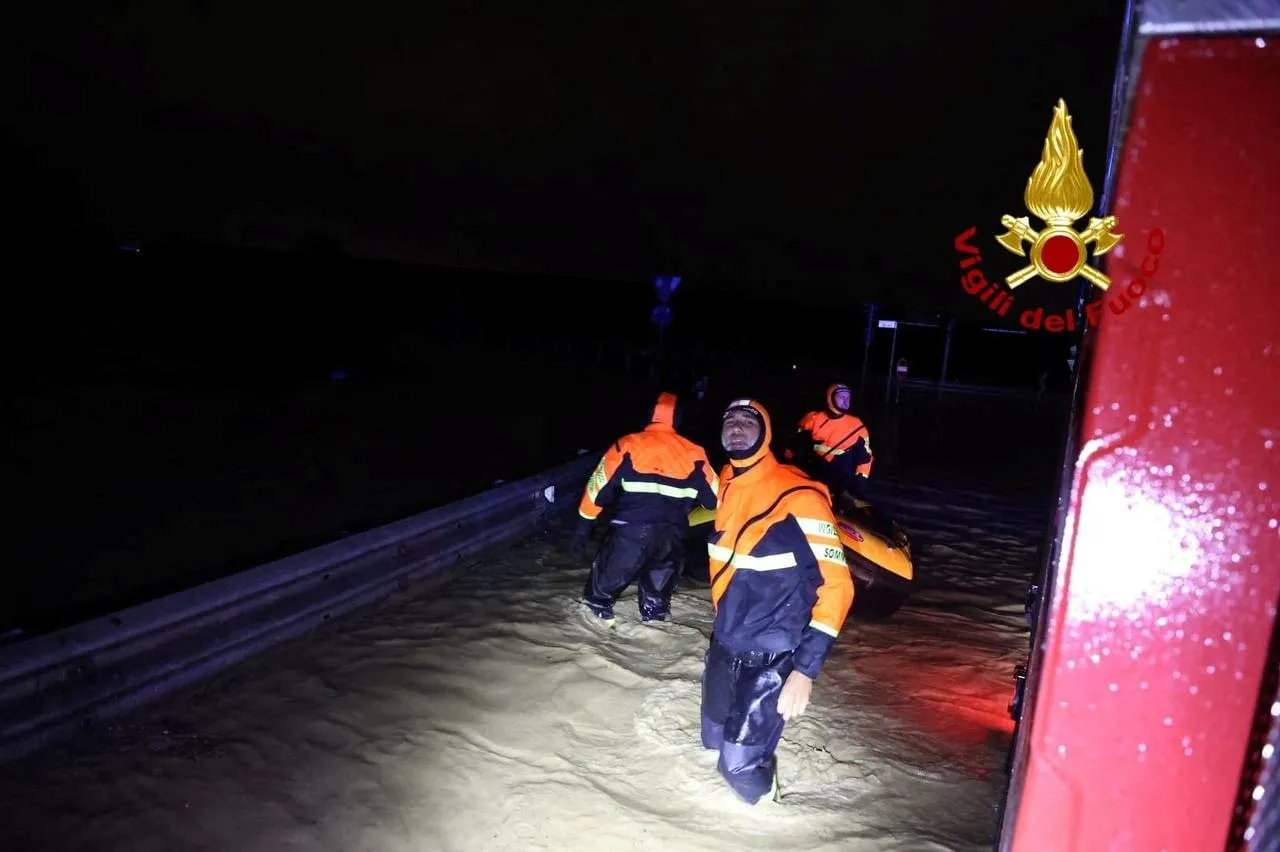 Italian firefighters work in flooded streets in Tuscany region